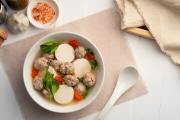 Clear soup with soy bean curd ,Minced Pork glass noodles and Vegetables in white bowl.Top view