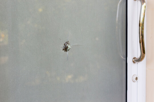 Glass door crack from bullet in Thailand