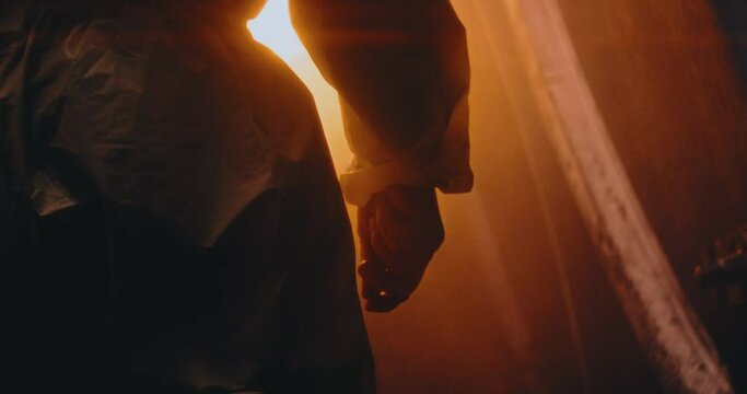 The video captures the back of a person in a protective suit and gas mask, standing in a dark nuclear bunker room post-nuclear aftermath, emphasizing readiness and isolation. Man Nuclear Reactor 