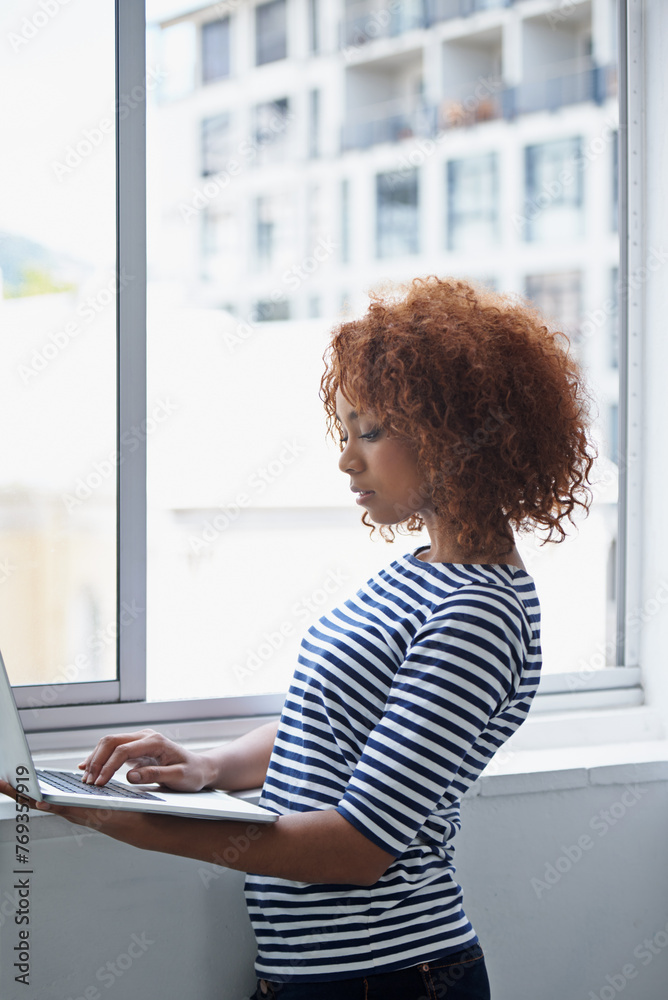 Poster office, window and black woman typing on laptop with research or online communication on email. crea