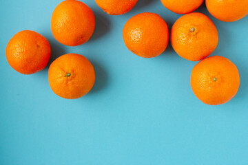Fresh oranges on light blue background with copy space. Bright horizontal photo of citrus fruits...