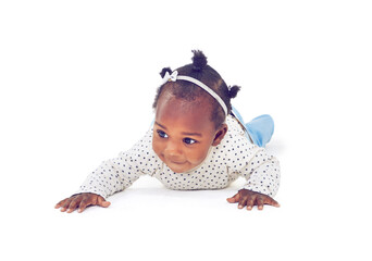 Baby, girl or crawling on tummy, development or progress of motor skill or balance on studio...