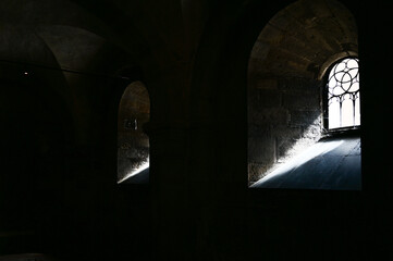 Rays of light or light falls in beautiful rays through an old church window and throws rays of...