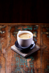 Cup of coffee on rustic wooden background. Copy space.	