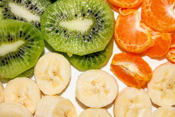 Banana.Kiwi.Mandarin.Slicing of fruits.Fruit background.Fruit mix.