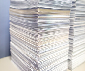 Stacks of papers on a table in the office