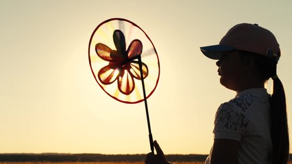 silhouette girls with toy spinner, sun wind toy spinner, family kid child daughter, girl windmill,...