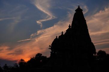 Silhouette of Kandariya Mahadev temple during Sunset with beautiful colorful sky background,...