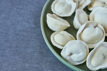 Homemade dumplings - russian pelmeni on plate