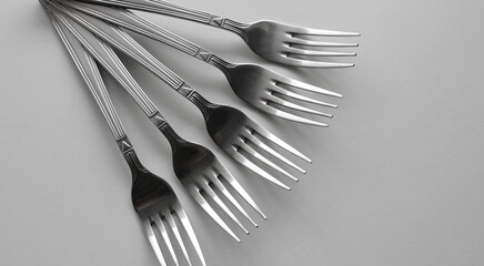 Table Settings Of Elegant Shiny Forks From One Cutlery Set 

