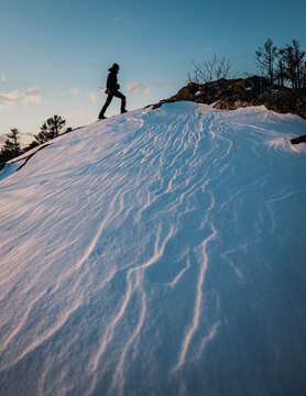 hiker walks through snow near summit of Borestone Mountain, Maine
