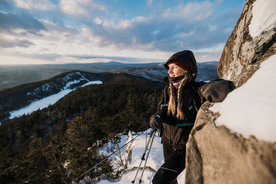 Female hiker on cold day in winter on mountain in Maine