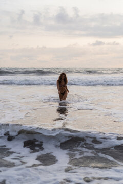 Portrait of cheerful young happy curly hair woman on the beach. Bali