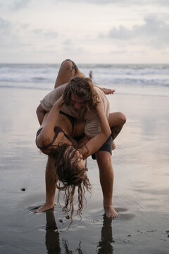 Young cheerful happy couple in love fooling around on the beach.