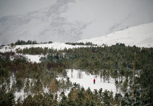 Unrecognizable traveler standing on snowy mountain