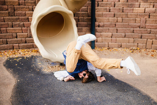 Playful tumble from playground slide