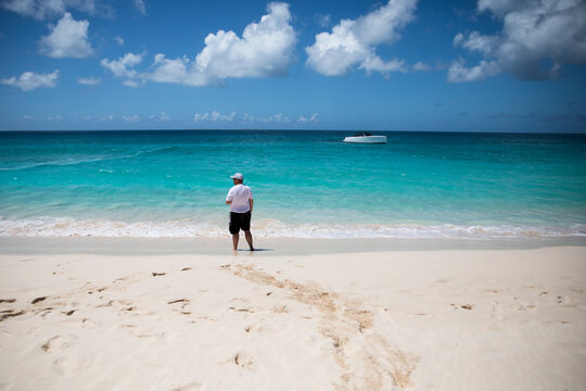 Wide Angle Rear View of Man Looking out at Caribbean Ocean