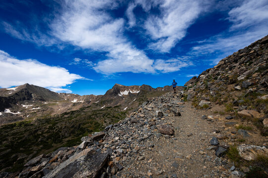 Trail runner on the trail up to Arapahoe Pass in Colorado.