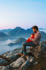 Family vacations - father traveling with baby in Norway hiking outdoor in mountains active healthy lifestyle trip man with child enjoying Lofoten islands aerial view, summer holidays together