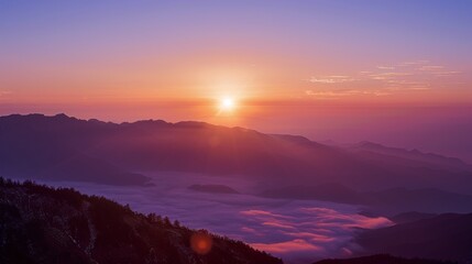 Fototapeta premium The sun is setting over the mountains, casting a warm glow over the landscape