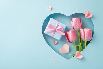 Deluxe Mother's Day snapshot, viewed from the top: tulips, a present adorned with a silk ribbon, paper hearts, and fashionable confetti through heart frame on a pastel blue background, space for text