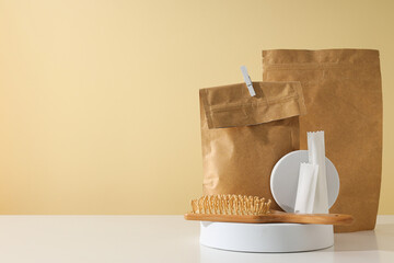 Paper bags with a wooden comb on a light background