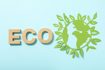 The word eco with a paper model of the Earth