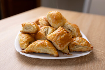 Freshly baked pies on a plate. Cooking pies.