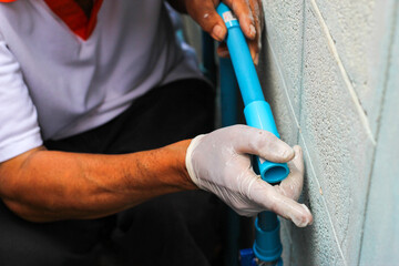 Plumbers are connecting pvc pipe. Plumbing repair service