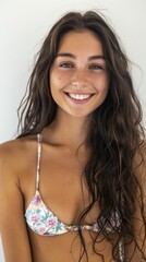 Ready for summer. Studio portrait of a gorgeous young woman smiling while posing in bikini against a white background