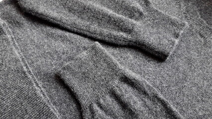 Dark gray cashmere sweater. Graphite sweater. Texture of natural wool.