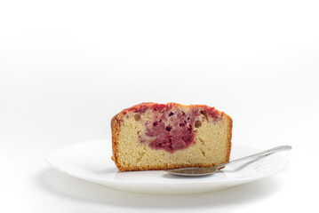 Portion of pound cake with strawberry jam on saucer, isolated on white background.