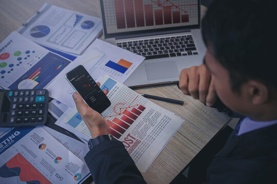 Businessman using smartphone checking business result and seriously by bad business results. Selected focus.	 - Powered by Adobe
