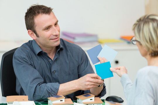 Portrait Of Couple Choosing Paint Colors