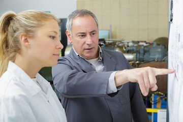 Fototapeta premium man and woman working in a robotics lab