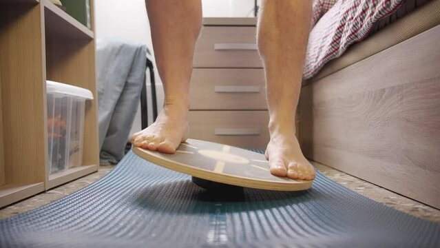 A male tries a balance board at home