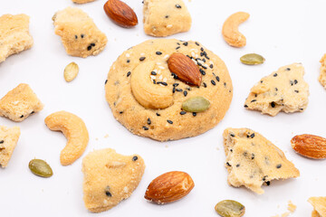 Whole Grain Cookies with crumbles and different seeds, cashew nuts, almond, black sesame, pumpkin seed on white background