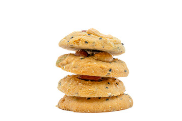 Fototapeta na wymiar Stack of Whole Grain Cookies with different seeds, cashew nuts, almond, black sesame, pumpkin seed on white background
