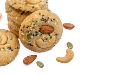 Stack of Whole Grain Cookies with different seeds, cashew nuts, almond, black sesame, pumpkin seed on white background with copy space