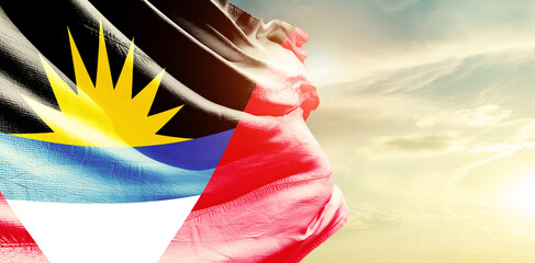 Antigua and Barbuda national flag waving in the sky. - obrazy, fototapety, plakaty