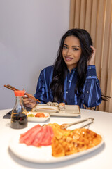 Beautiful Brazilian woman eating sushi - 769497599
