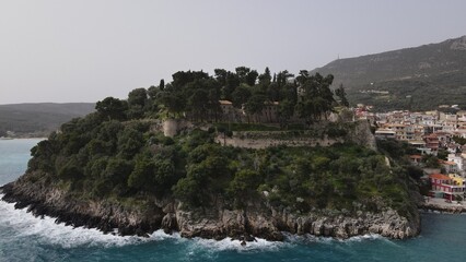 Fototapeta premium aerial view wild sea waves crushing on rocks in parga town epirus greece