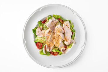 Light diet salad. Thinly sliced chicken fillet grilled with herbs on a white plate. Banquet festive dishes. Gourmet restaurant menu. White background.