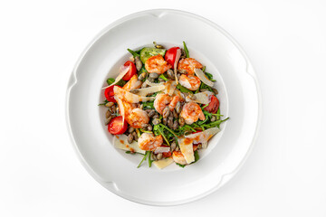 Easy diet salad with shrimp, pumpkin seeds and greens  on a white plate. Banquet festive dishes. Gourmet restaurant menu. White background.