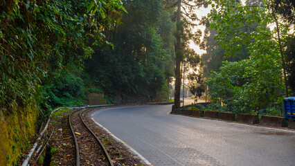 View of The 2 ft narrow gauge line of Darjeeling Toy train, Along with the Tarmac Road,  that runs...