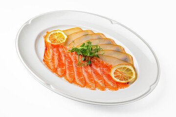 Slices of delicatessen salmon and buttery salted fish on a white plate. Banquet festive dishes. Gourmet restaurant menu. White background.