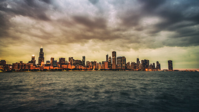 Panoramic image of Chicago skyline at sunset with dramatic sky.