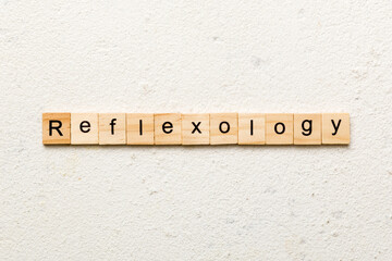 reflexology word written on wood block. reflexology text on cement table for your desing, concept