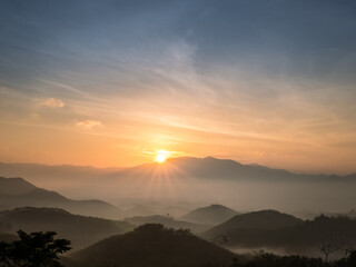 Sunrise scene with mountain and sea of mist