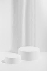 Two white round podiums with striped column as geometric decor, mockup on white background. Template for presentation cosmetic products, gifts, goods, advertising in contemporary black friday style.